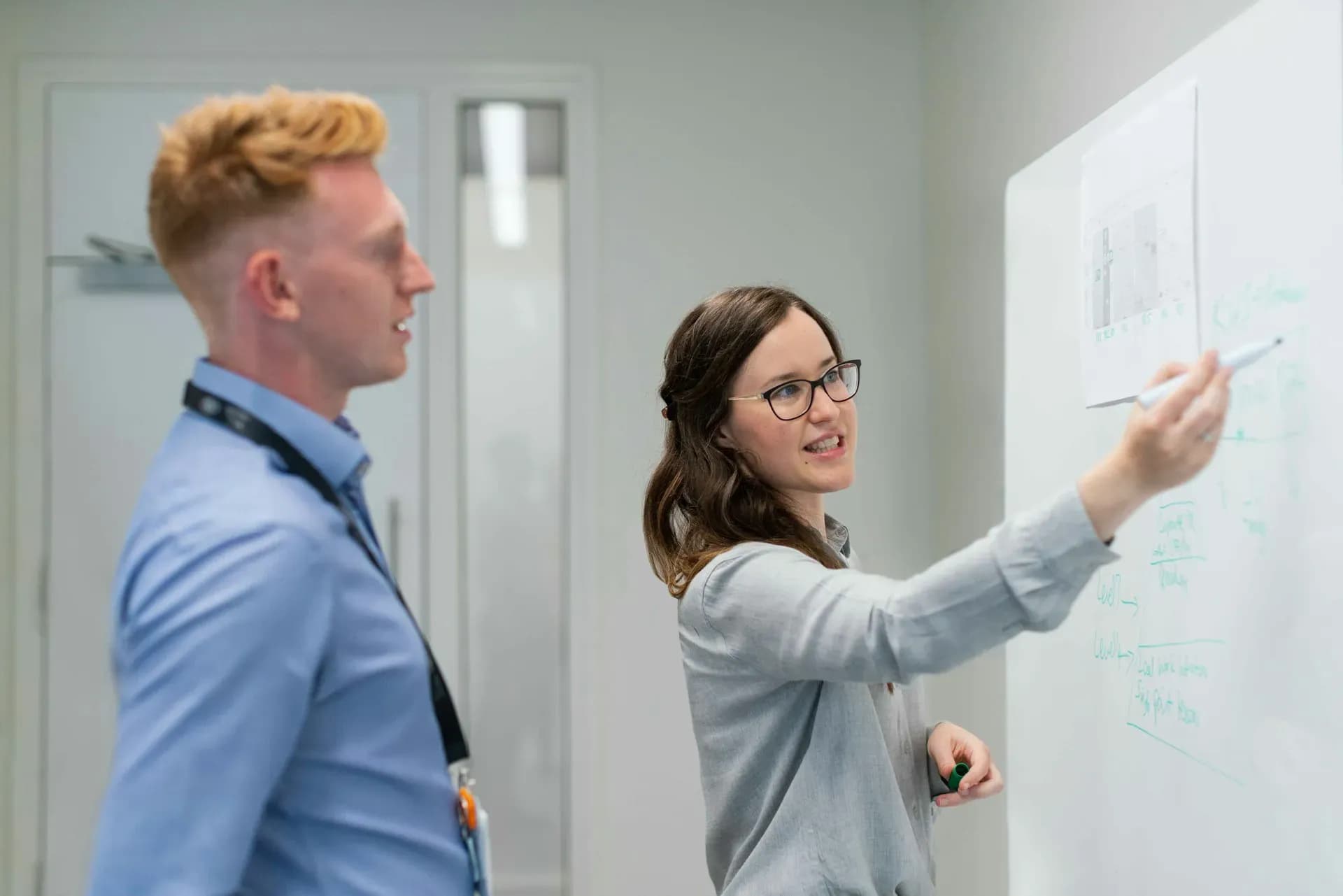 Woman and man at a whiteboard