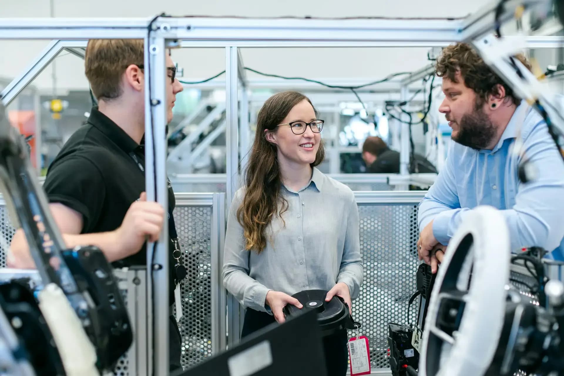 Female engineer talking with two male engineers